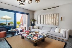 a living room with a couch and a table at Root Redrock Villas Yalıkavak in Yalıkavak