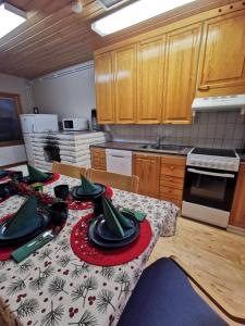 a kitchen with a table with plates on it at Aurora House in Pello