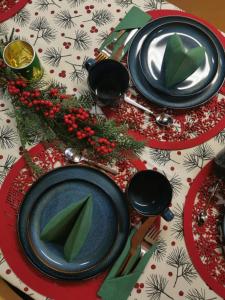 a table with black plates and green napkins on it at Aurora House in Pello +13 photos