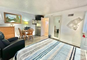a living room with a bed and a dining room at Flora Motel in Flora