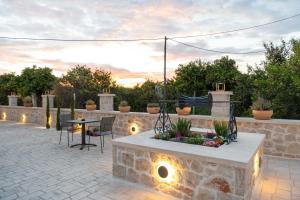 a patio with a table and chairs and lights at Antaia 1 in Nafplio +3 photos