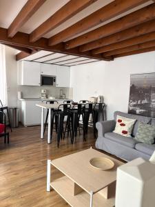 a living room with a couch and a table at Marne appartements in Nogent-sur-Marne