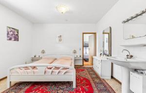 a white bedroom with a bed and a sink at Appartement in de buurt van winterberg in Winterberg