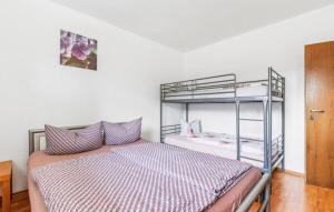 a bedroom with a bunk bed with purple pillows at Appartement in de buurt van winterberg in Winterberg