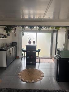 a kitchen with a table and a sink and a counter at Pause confortable, escapade culturelle in Caen