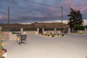 a patio with a table and chairs in front of a building at Antaia 2 in Nafplio +4 photos
