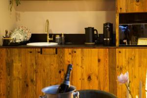 a kitchen with a wooden counter top with a sink at La chambre du moulin dort in Chénelette +7 photos