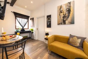 a living room with a yellow couch and a table at Sea house Lea in Novi Vinodolski