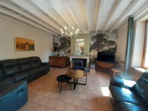 a living room with a couch and a table at LE SOURCIER in Argançon