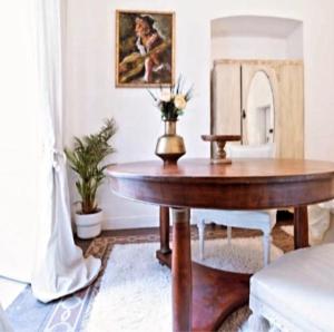 a wooden table in a living room with a table at Visconti suite and spa in Catania