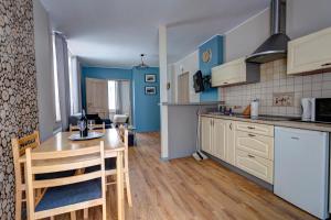 a kitchen with a table and a dining room at Apartamenty Parkowa in Krynica Zdrój