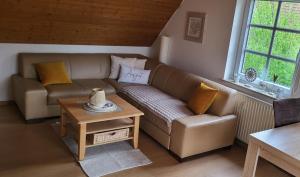 a living room with a couch and a table at lüttje Meerzeithuus in Carolinensiel +19 photos
