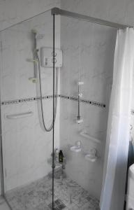 a bathroom with a shower and two toilets in it at Katie's Cottage in Laghy +9 photos