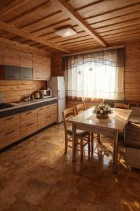 a kitchen with a table and chairs in a room at Гостинний двір in Vorokhta