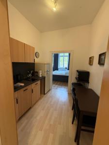 a kitchen with a table and a dining room at Fürstenhof Belle Etage Altstadt- Parkplatz im Innenhof in Wismar