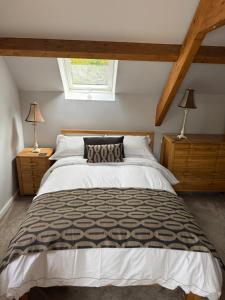 a bedroom with a large bed and two lamps at Shepherds Barn in Beamish