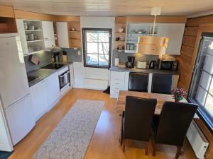 a kitchen with a wooden table and a dining room at Gold Digger's Timber in Inari