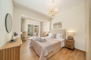 a bedroom with a large bed and a dining room at Nefeli Duplex Apartment in Karavomylos