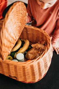 a basket full of fruit and vegetables on a table at Les Terrasses du Grillon in Chambon-sur-Lac