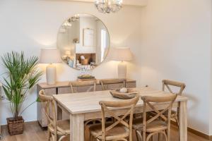 a dining room with a table and a mirror at Nefeli Duplex Apartment in Karavomylos