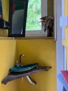 a bathroom with a sink and a window at Pousada ilha das gamelas in Guaraqueçaba