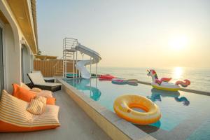 a swimming pool with a slide at SunRise Beachfront Cha am in Ban Bang Ket