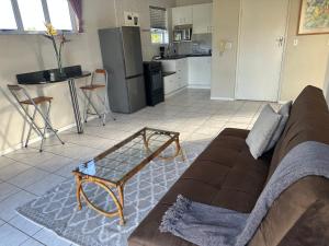 a living room with a couch and a kitchen at Loft Style Apartment in Monte Vista