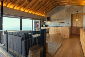 an open kitchen with a large window and a counter at Casa da Rocha in Terra Alta