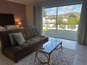a living room with a couch and a large window at Loft Style Apartment in Monte Vista