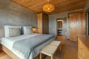 a bedroom with a large bed and a table at Casa da Rocha in Terra Alta