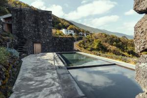 a swimming pool in the middle of a building at Casa da Rocha in Terra Alta