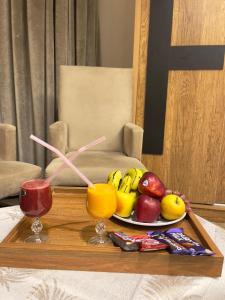 a tray with a plate of fruit on a table at Casa Latina pyramids view in Cairo