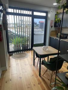 a table and chairs in a room with a large window at Salina Ria Studio 2 in Aveiro