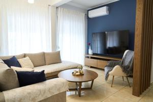 a living room with a couch and a tv at Lagoon Dream in Fanari