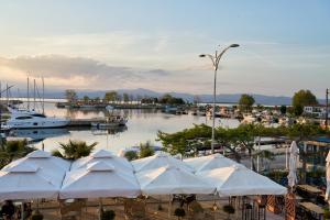 a marina with white umbrellas and boats in the water at Lagoon Dream in Fanari