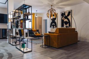 a living room with a couch and a shelf with vases at Portico Provenzali in Cento
