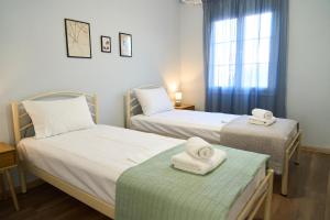 two beds in a room with towels on them at Lagoon Dream in Fanari