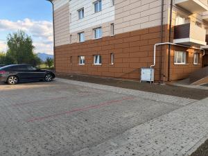 a car parked in a parking lot next to a building at Nico's Place in Sînpetru