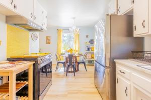 a kitchen with a dining table and a refrigerator at Sunshine Loft in Wrightwood