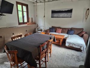 a living room with a table and a couch at Ancienne étable in Pierrefitte-sur-Sauldre