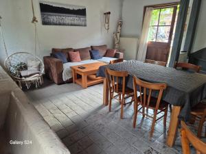 a living room with a table and a couch at Ancienne étable in Pierrefitte-sur-Sauldre
