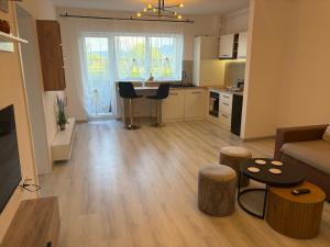 a living room with a couch and a table and a kitchen at Nico's Place in Sînpetru