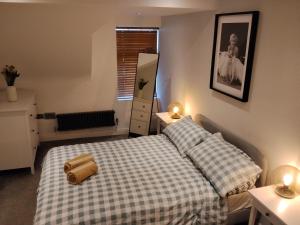 a bedroom with two beds and a mirror at Modern Town Apartment with Terrace in West Kirby