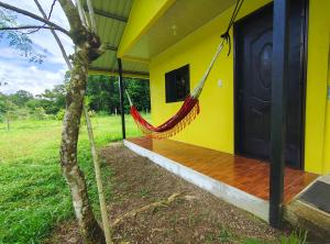 a hammock hanging from the side of a house at Finca Paz y Flora in Drake