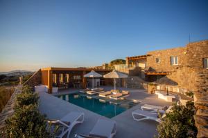 a villa with a swimming pool and a building at Mystic Harmony in Mikonos