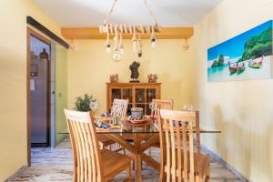 a dining room with a wooden table and chairs at Premium Oceanside Apartment, Pool, Parking in Port Saplaya