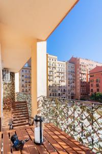 a table on a balcony with a view of buildings at Premium Oceanside Apartment, Pool, Parking in Port Saplaya