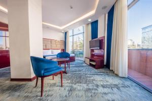 a hotel room with a bed and a table and chairs at Denis Hotel Tbilisi in Tbilisi City +78 photos