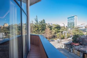 a balcony with a view of the city at Denis Hotel Tbilisi in Tbilisi City