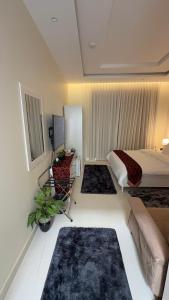 a bedroom with a bed and a couch and a table at دار طيبة in Medina